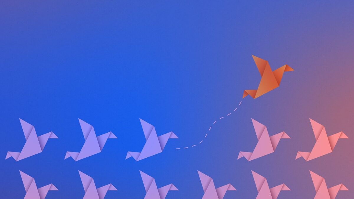 A single paper bird breaks away from the flock and rises above the competition.