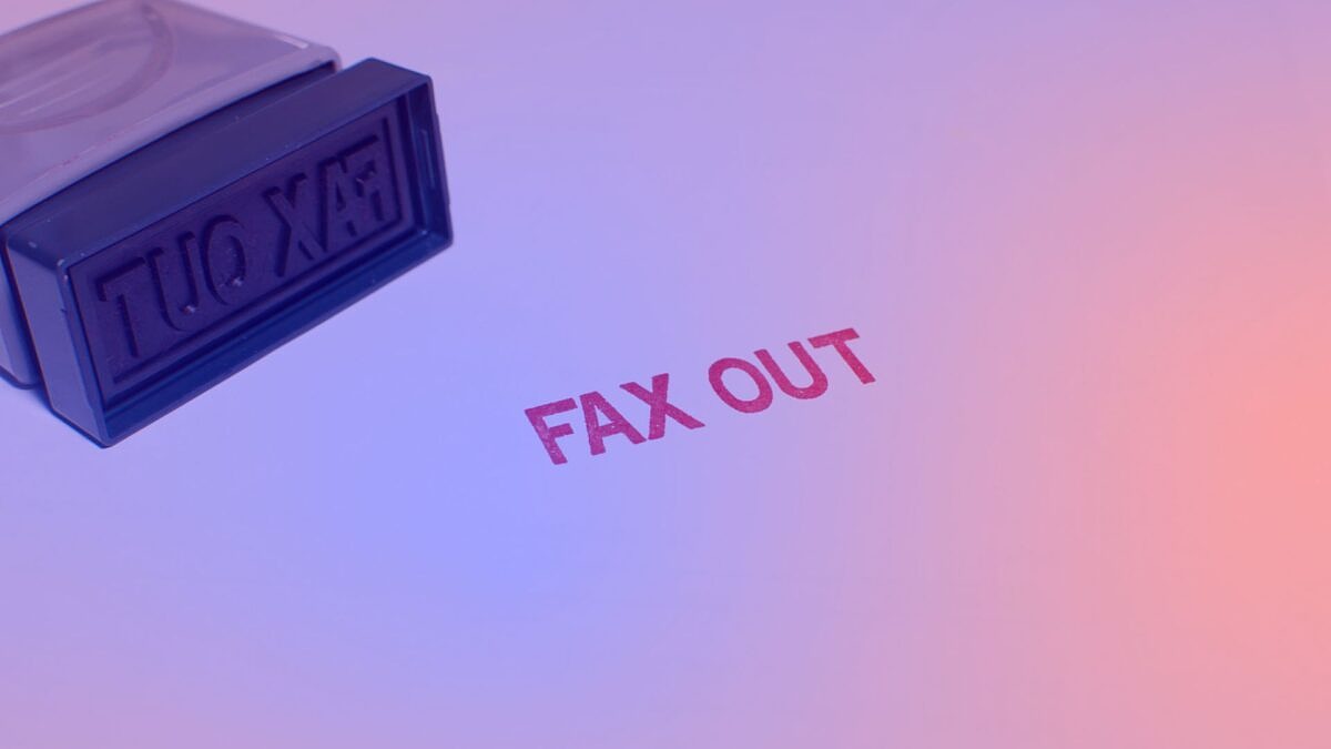Stempel mit Aufdruck „Fax Out“ als Symbol für veraltete Prozesse – KI im Mittelstand als Lösung